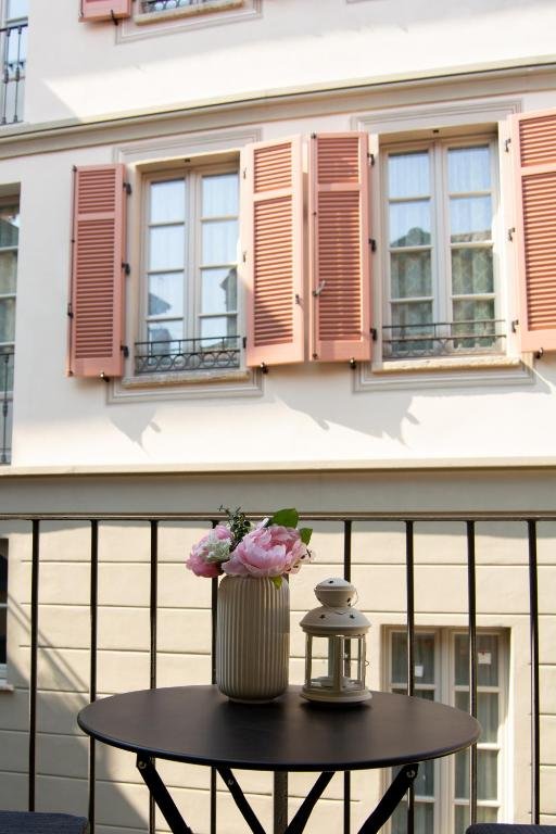Tavolino con fiori sul balconcino affacciato sulla via